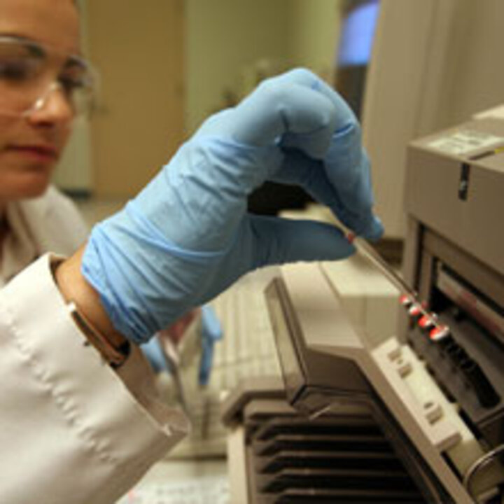 Scientist places samples in a device